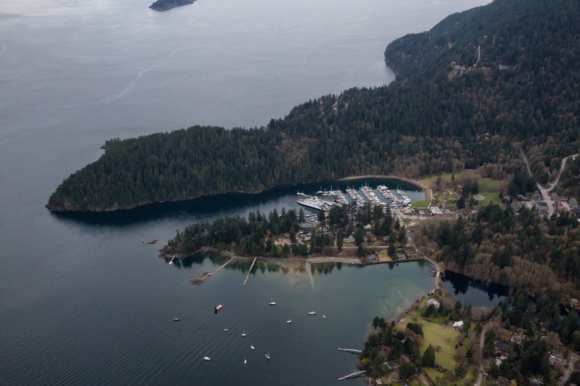 Aerial view of Bowen Island marina, ferry, and forested coastline