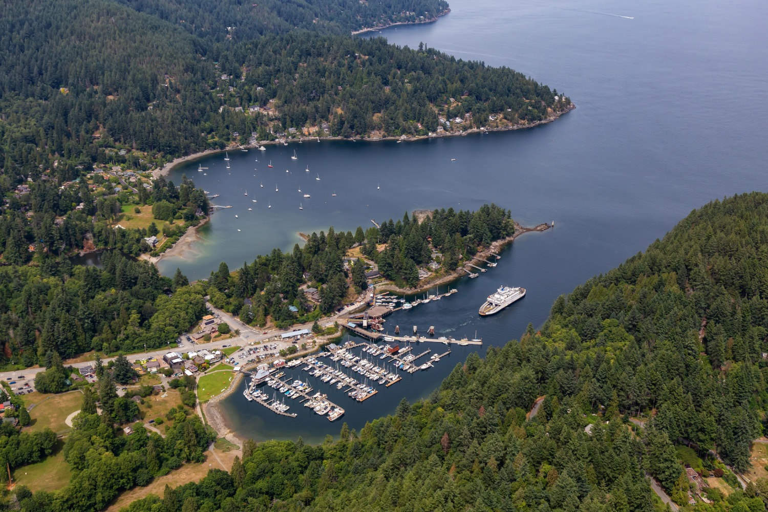 Aerial view of Bowen Island marina, ferry, and forested coastline